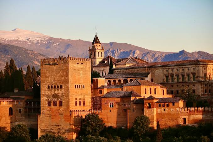 The Alhambra palace complex in Granada, Spain at sunset — the last great monument of Moorish civilisation in Europe, which fell in 1492 and whose spirit crossed the strait to Morocco